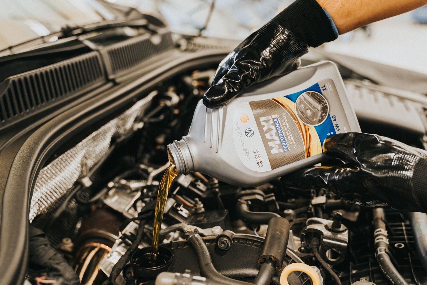 Versement d'huile moteur depuis un bidon dans un moteur
